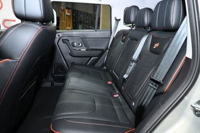Black leather rear seats with orange stitching and integrated seatbelts
