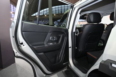 Rear door interior panel with black leather and orange stitching