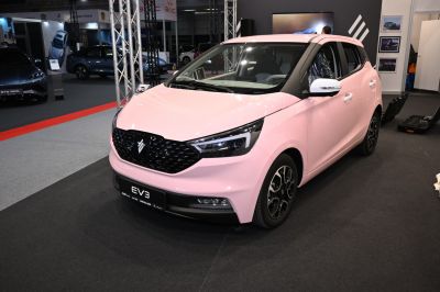 Compact electric hatchback with LED headlights and black grille