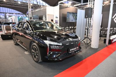 Front view of a black electric sedan with LED headlights and aerodynamic design.