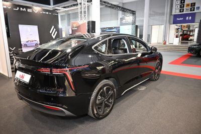 Rear view of sleek black electric sedan with LED taillights and aerodynamic styling