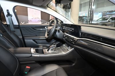 Modern car interior with digital dashboard and black leather seats.