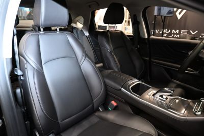 Black leather front seats with detailed stitching and modern center console
