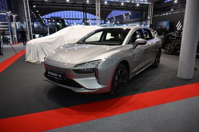 Modern electric sedan with sleek aerodynamic front and LED headlights