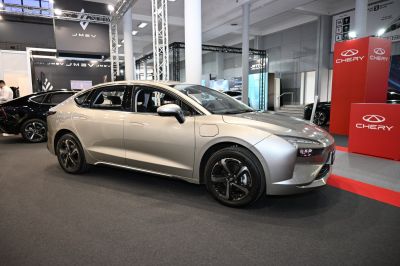 Silver electric sedan with aerodynamic body and LED headlights