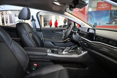Black leather seats and touchscreen infotainment in a modern car interior