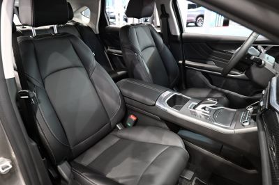 Premium black leather seats with white stitching and sleek center console.