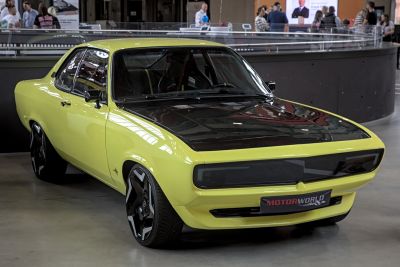 Yellow coupe with black hood and modern black rims