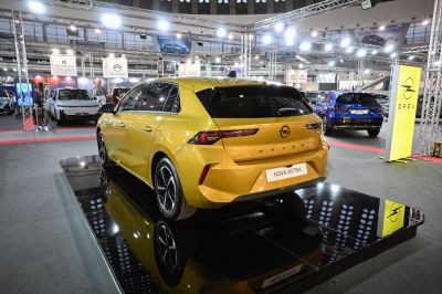 Rear view and taillights of a vibrant yellow hatchback car