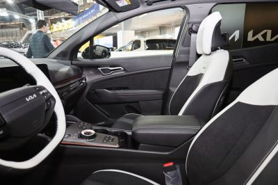 Dual-tone upholstery and central control dial inside a modern vehicle interior