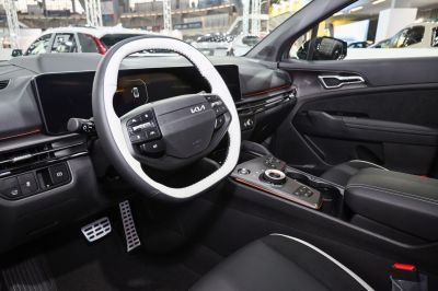 Digital dashboard and multifunction steering wheel in car interior.