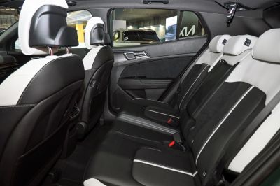 Two-tone black and white rear seats with armrest and door interior