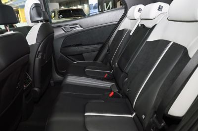Stylish black and white rear seat interior with headrests and seat belts