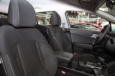 Black front seats with white stitching and modern gear shift console