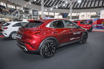 Rear and side view of a red crossover with black alloy wheels and modern tail lights