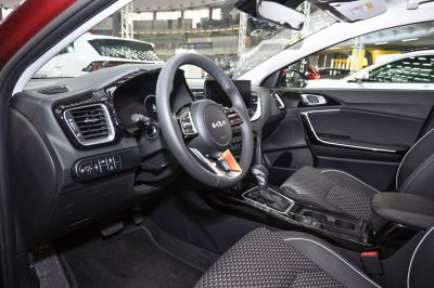 Modern steering wheel with controls and automatic gearshift in vehicle interior.
