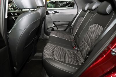 Rear seat interior with black leather and patterned fabric upholstery