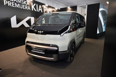 Boxy electric van with futuristic front design and black-white contrast.