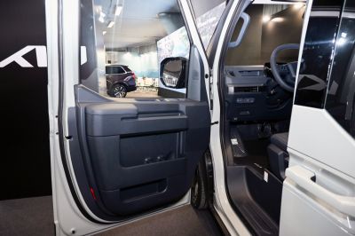 Interior door panel and driver's seat with steering wheel.