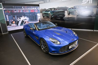 Convertible sports car with prominent front grille and sleek headlights