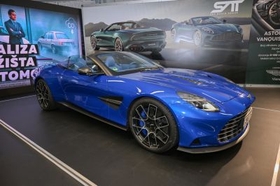 Blue luxury convertible sports car showing front-side profile