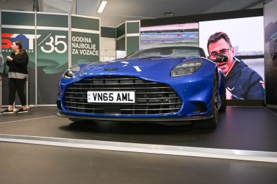 Front grille and headlight close-up of blue convertible sports car