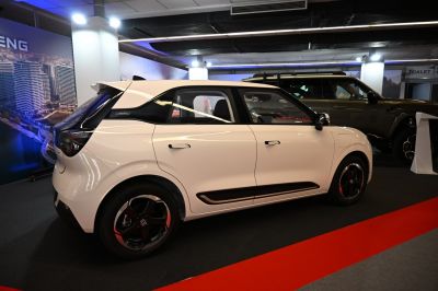Compact hatchback side profile with black-accented design and modern wheels