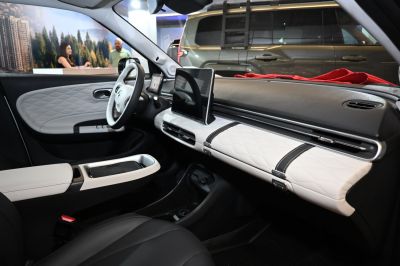 Modern car interior with digital dashboard and quilted white panels