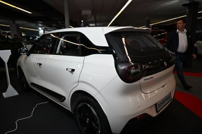 Rear side view of a sleek white hatchback with black window trim and modern tail lights