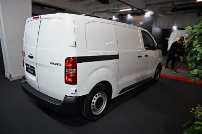 Rear side of white Toyota cargo van with vertical taillights and dual rear doors