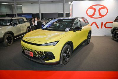 Yellow SUV with sharp headlights and black roof accents front side view