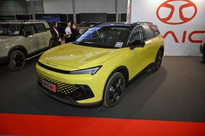 Yellow compact SUV with sharp LED headlights and black roof
