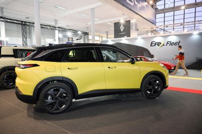 Yellow compact SUV side view with black roof and modern wheels
