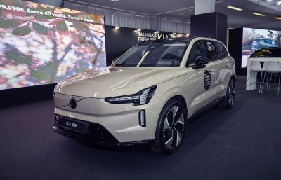 Front three-quarter view of a modern electric SUV with sharp LED headlights and distinctive wheels.