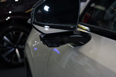Close-up of side mirror with integrated camera on a modern SUV