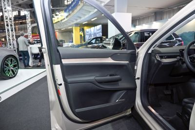 Volvo EX90 interior door panel with black leather and wood trim