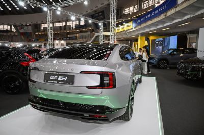 Rear view of electric sedan with sleek, modern taillights and dynamic lines.