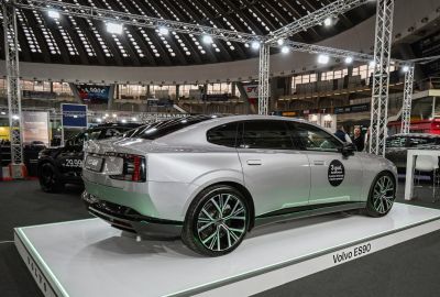 Silver electric sedan rear and side view with alloy wheels and sleek design