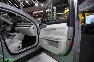 Modern car interior with digital display and white leather seats