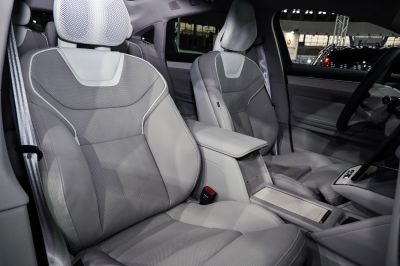 Luxurious perforated leather front seats and center console of a modern vehicle.