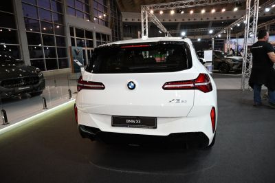 Rear view of a white SUV with sleek horizontal taillights and sporty rear design