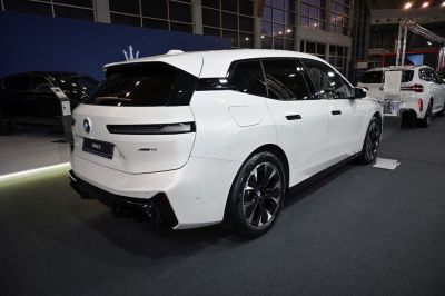 Rear side view of modern electric SUV with distinctive wheels
