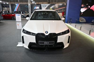 Large grille and sleek angular headlights on white SUV front.