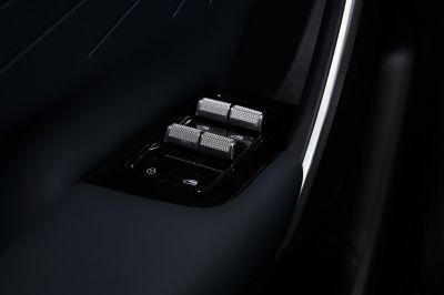 Metallic textured window switches and door lock buttons on car door panel