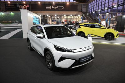 White electric SUV front with sleek headlights and distinct grille.