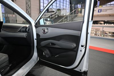 Modern car door panel with speaker and armrest