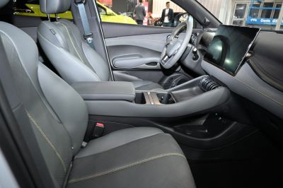Modern car interior with dual digital displays and leather seats.