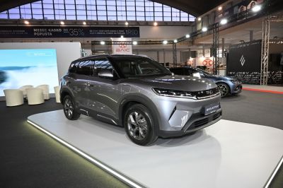 Streamlined electric SUV with sharp LED headlights on display platform