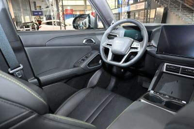 Futuristic steering wheel and digital dashboard interior with black upholstery
