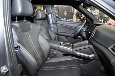 Sporty front seats with stitched upholstery and modern dashboard with touchscreen display